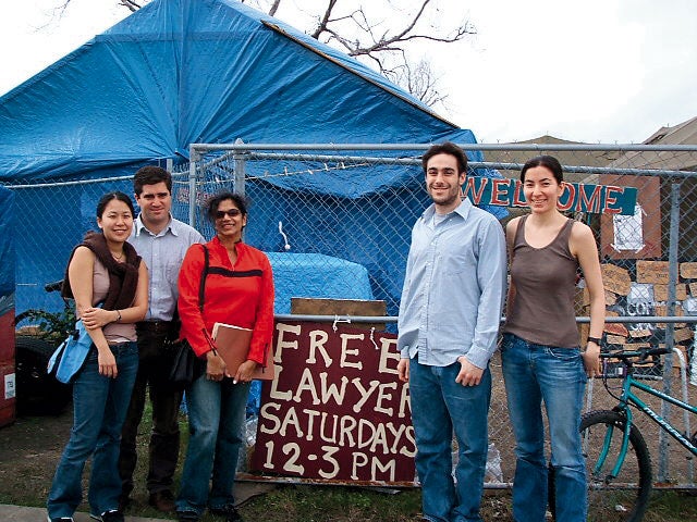 Group of students standing in front of a sign that reads