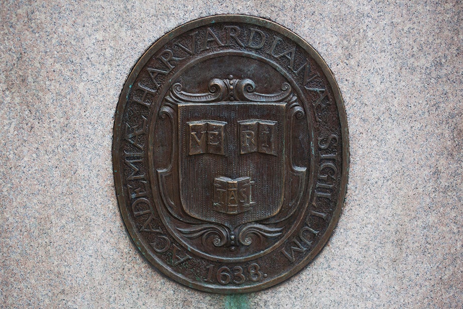 Close up of a metal decorative shield applied to an outdoor stone façade