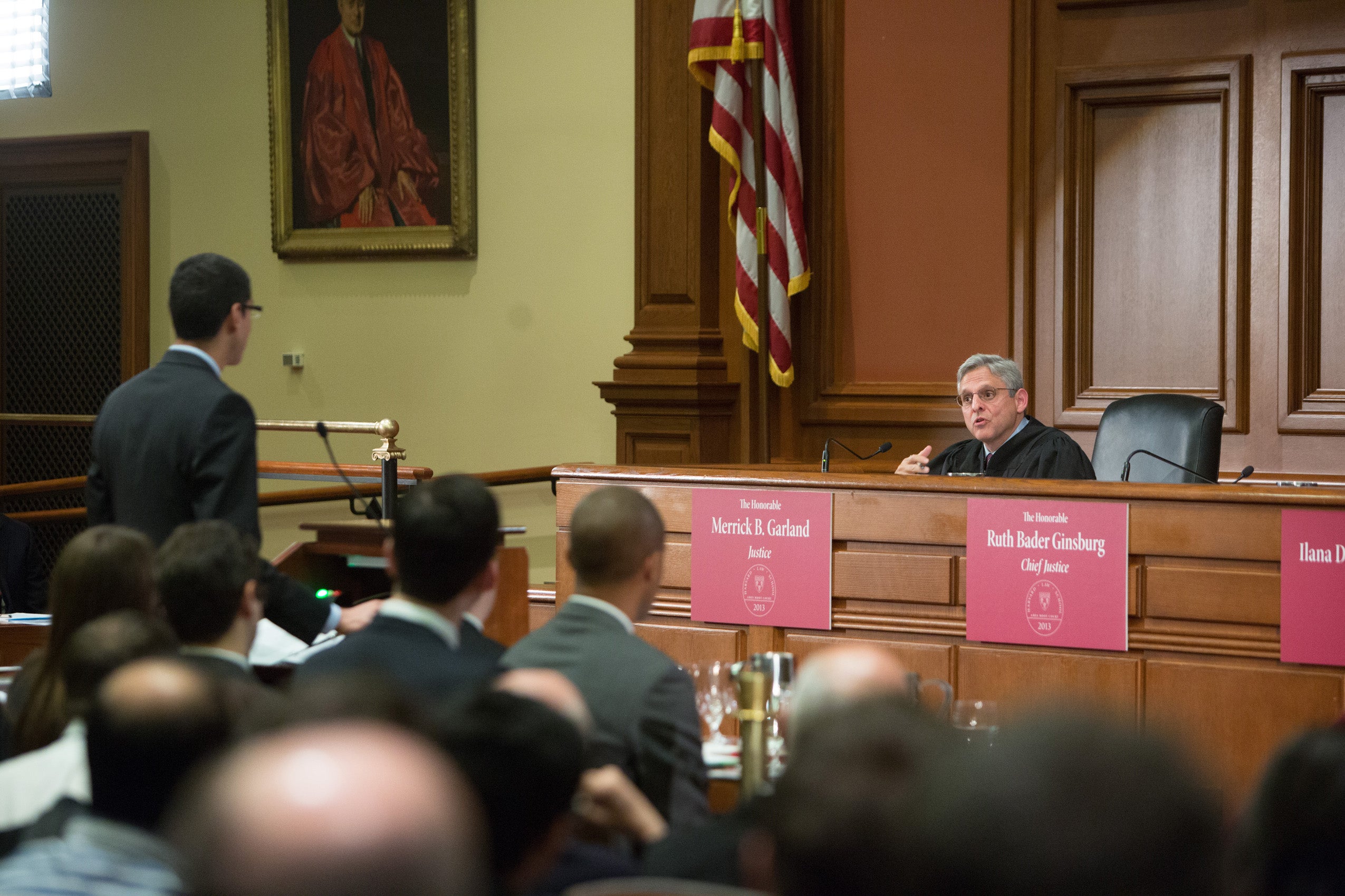 Merrick Garland behind the desk in a courtroom