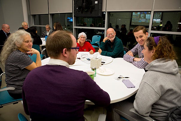 Attendees gathered sitting at a round table in discussion