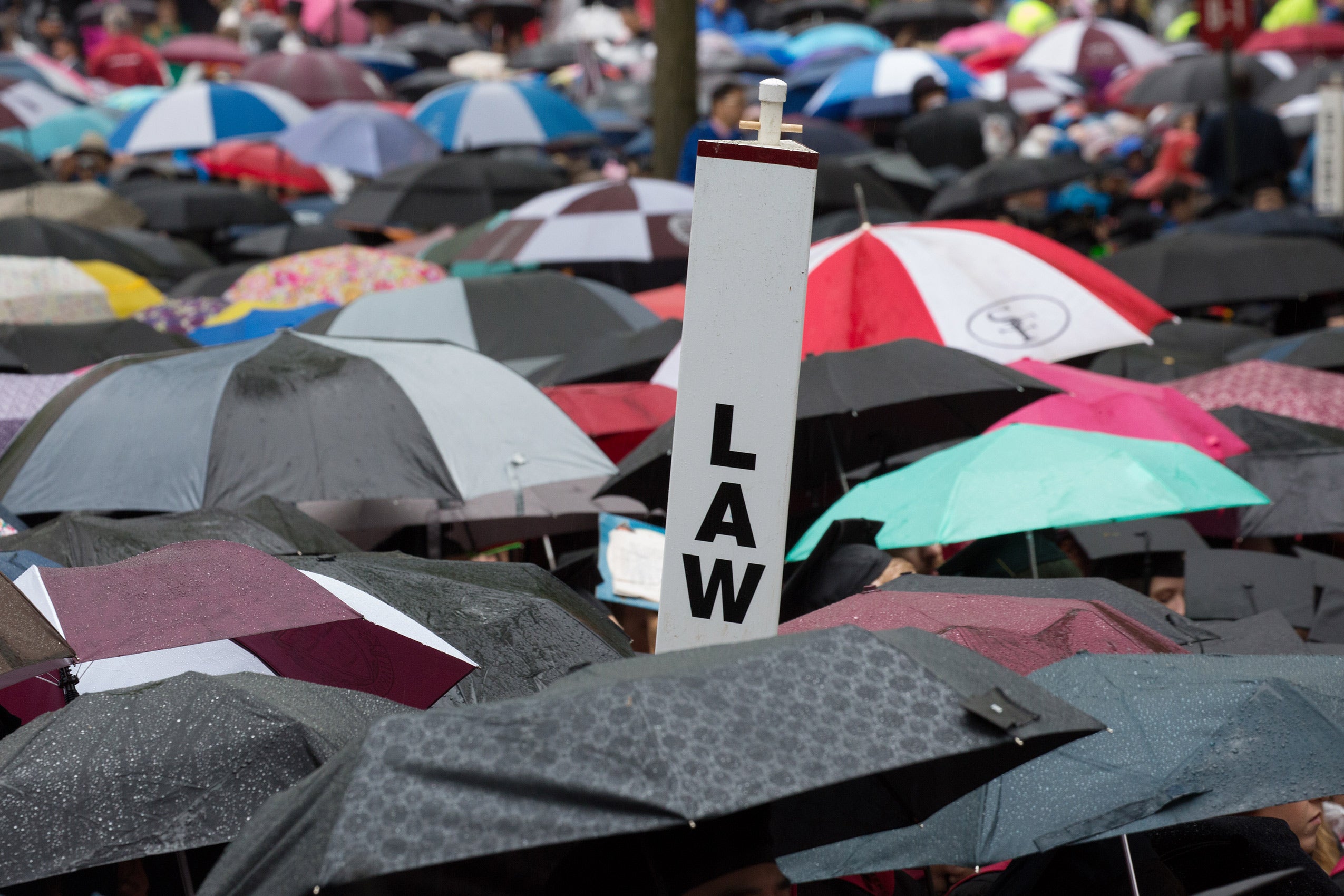 A sign reading 'LAW' among several umbrellas