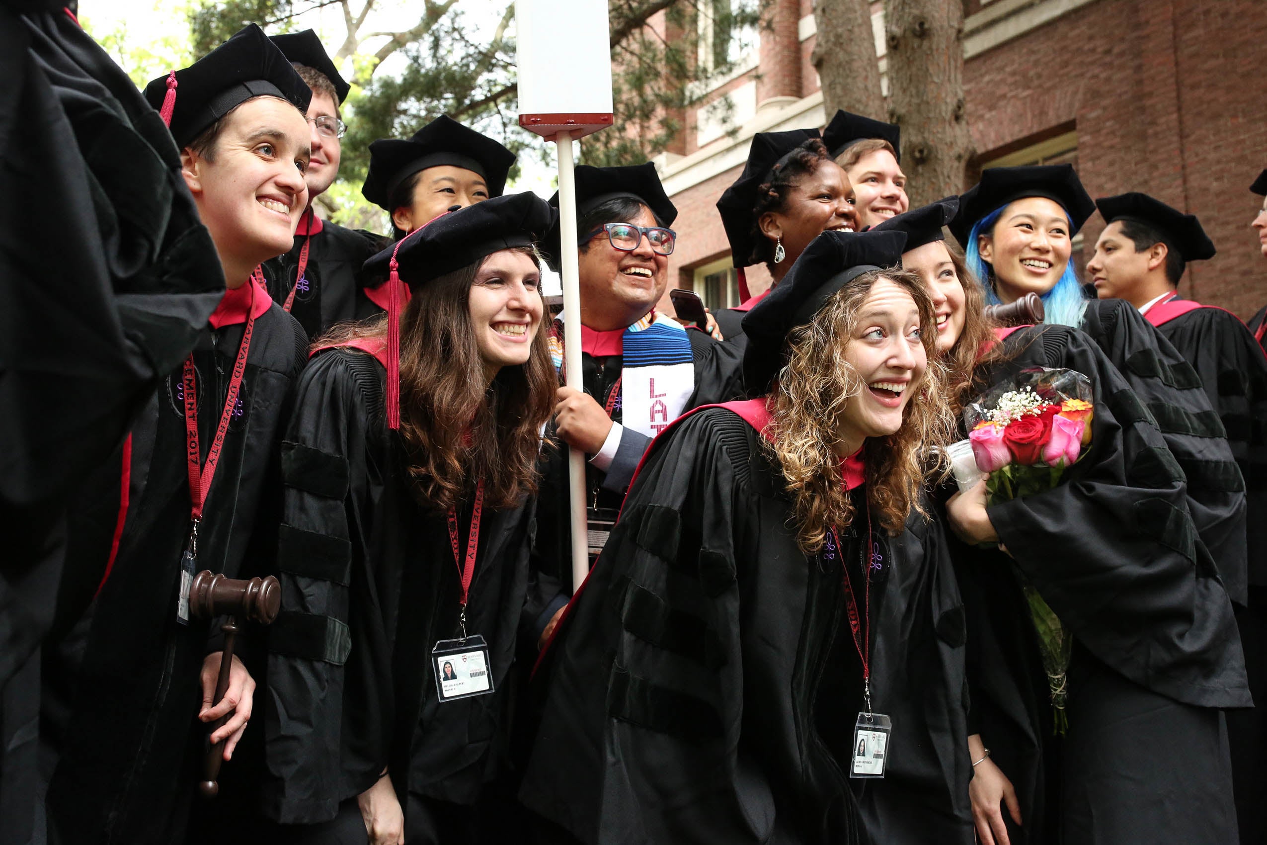 A group of students in caps and gowns, smiling for a photo