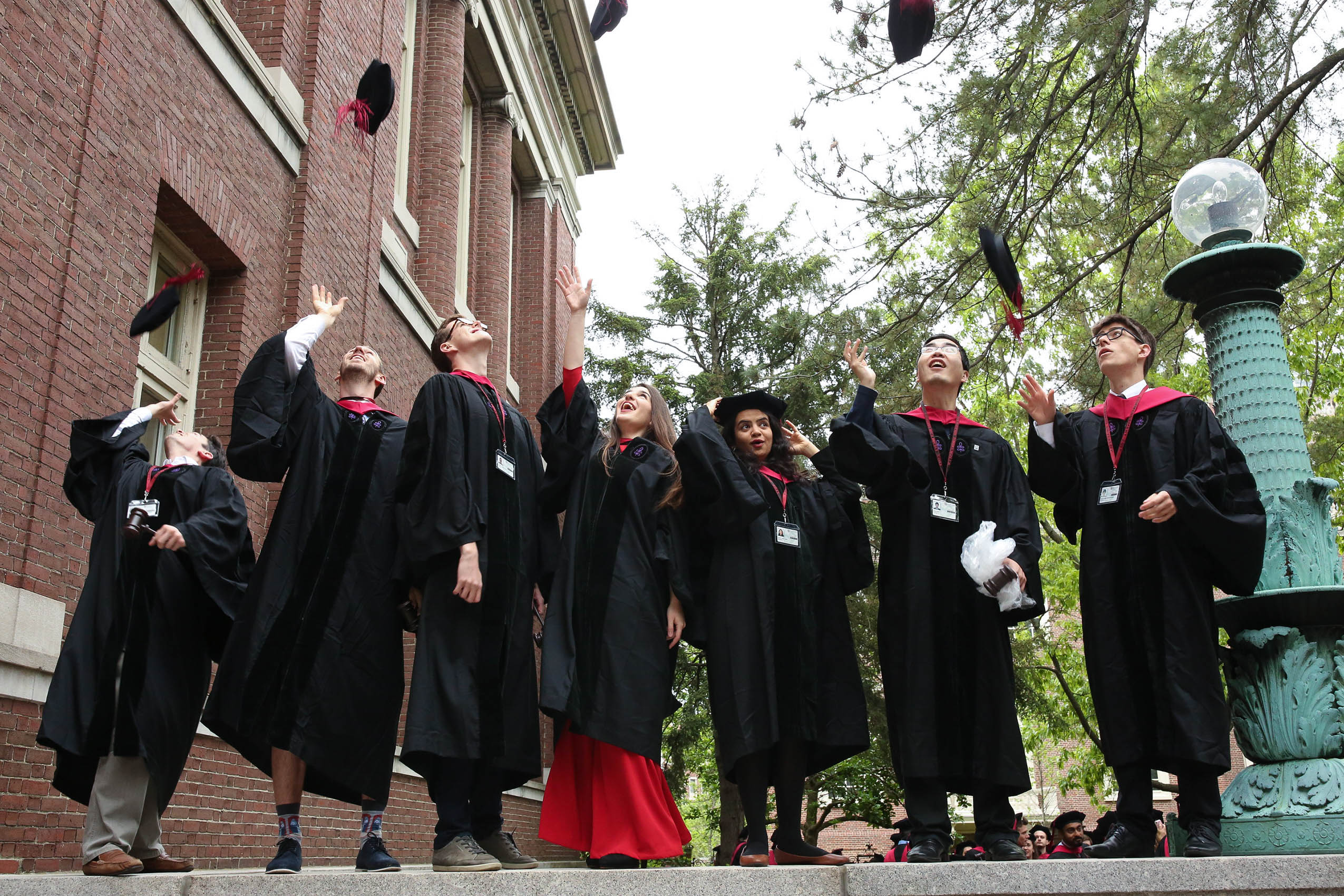 A group of students tossing their grad caps into the air