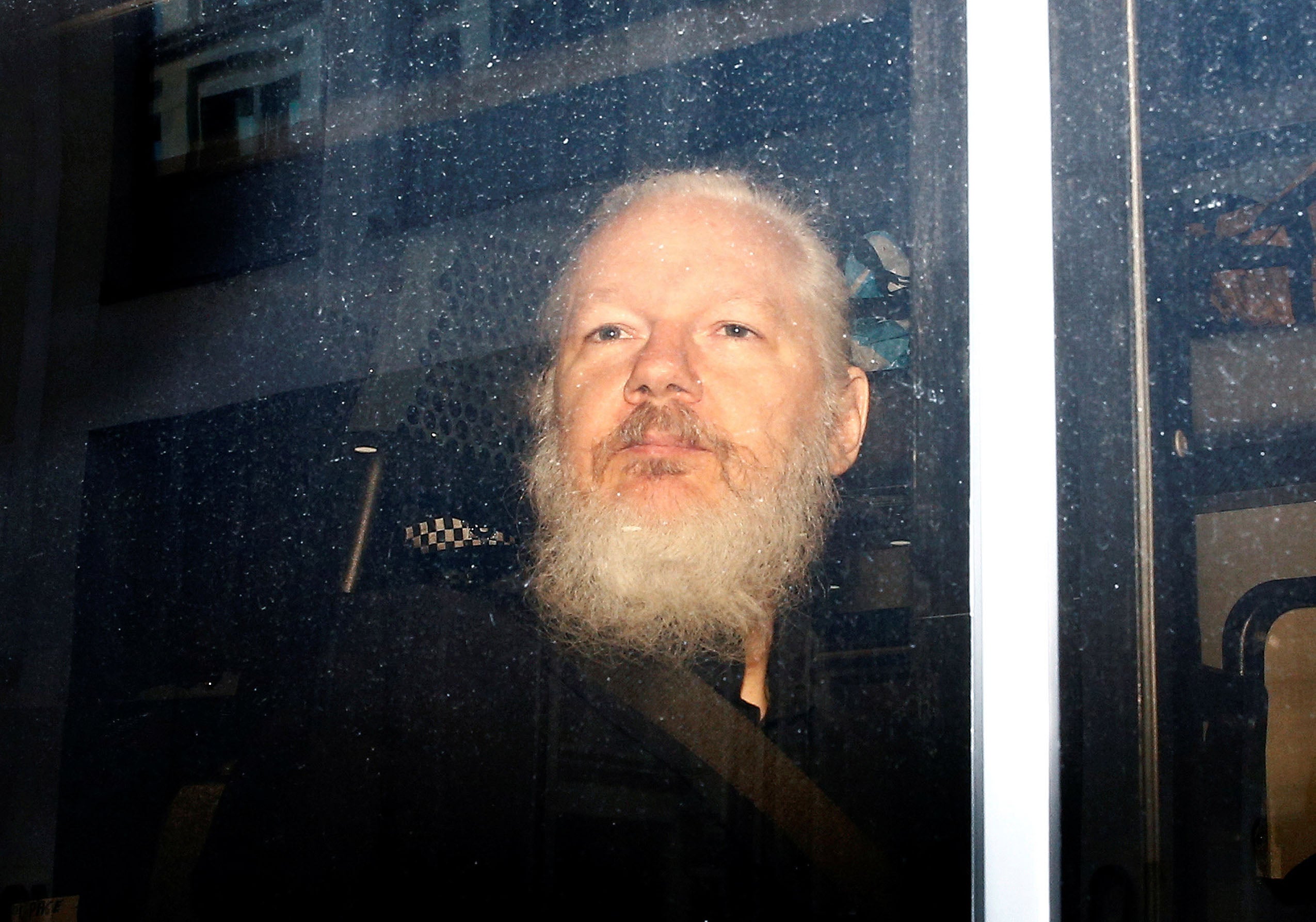 Julian Assange in a police van