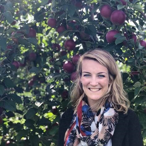 headshot photo of Elizabeth Melampy in front of an apple tree