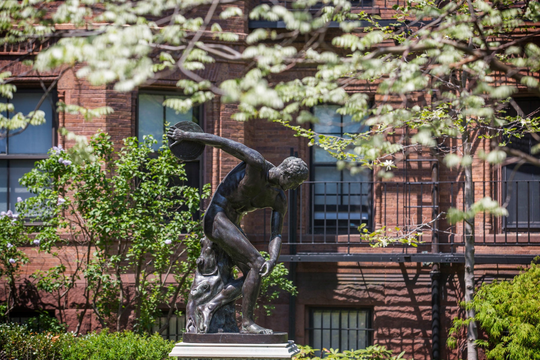 Statue of man holding a disk
