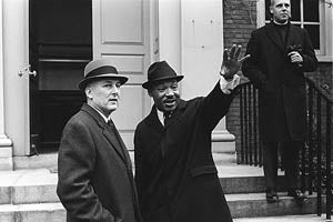 Rev. Martin Luther King Jr. waves, standing next to Harvard President Nathan M. Pusey.