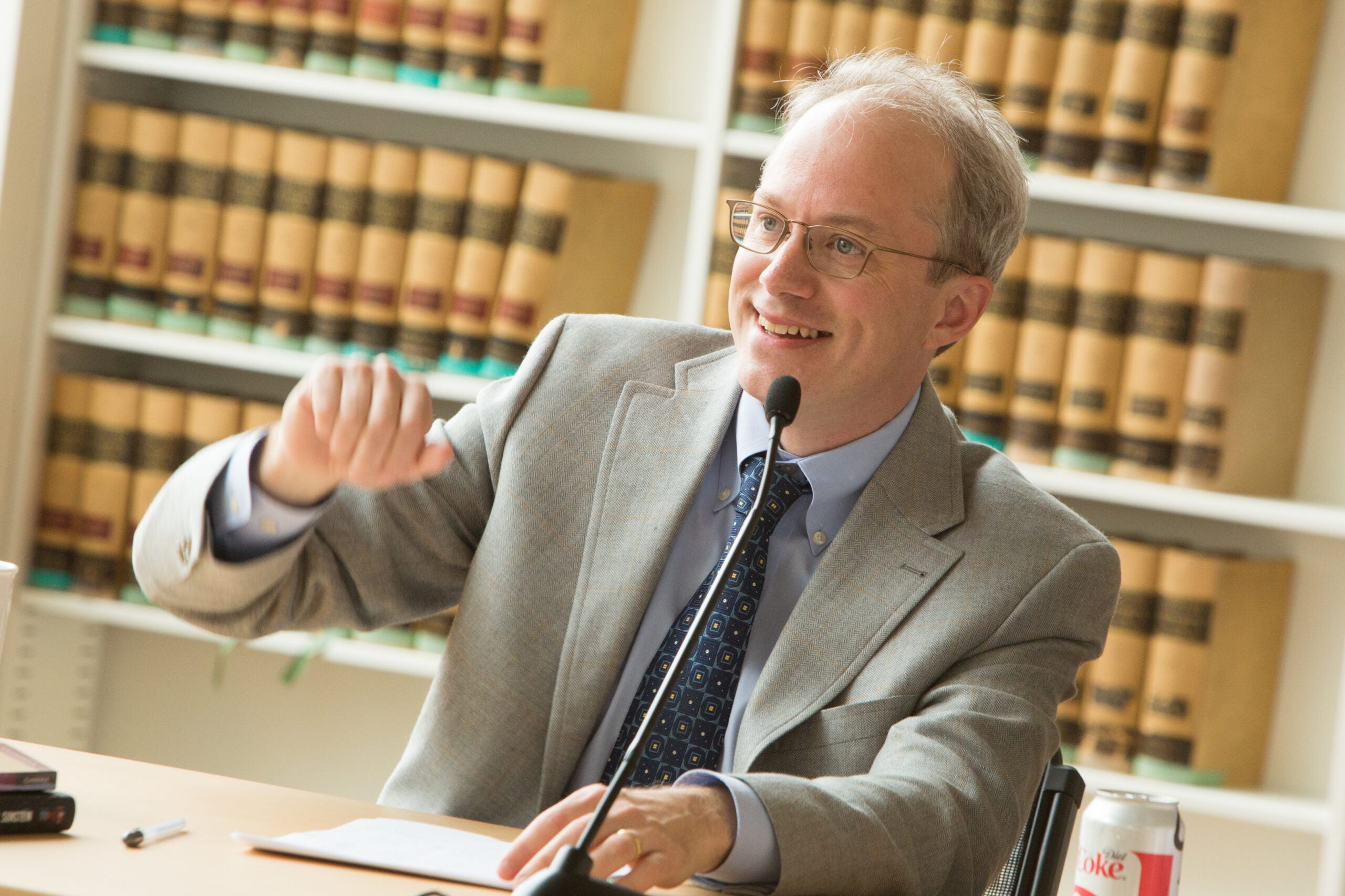 Adrian Vermeule at a desk smiling