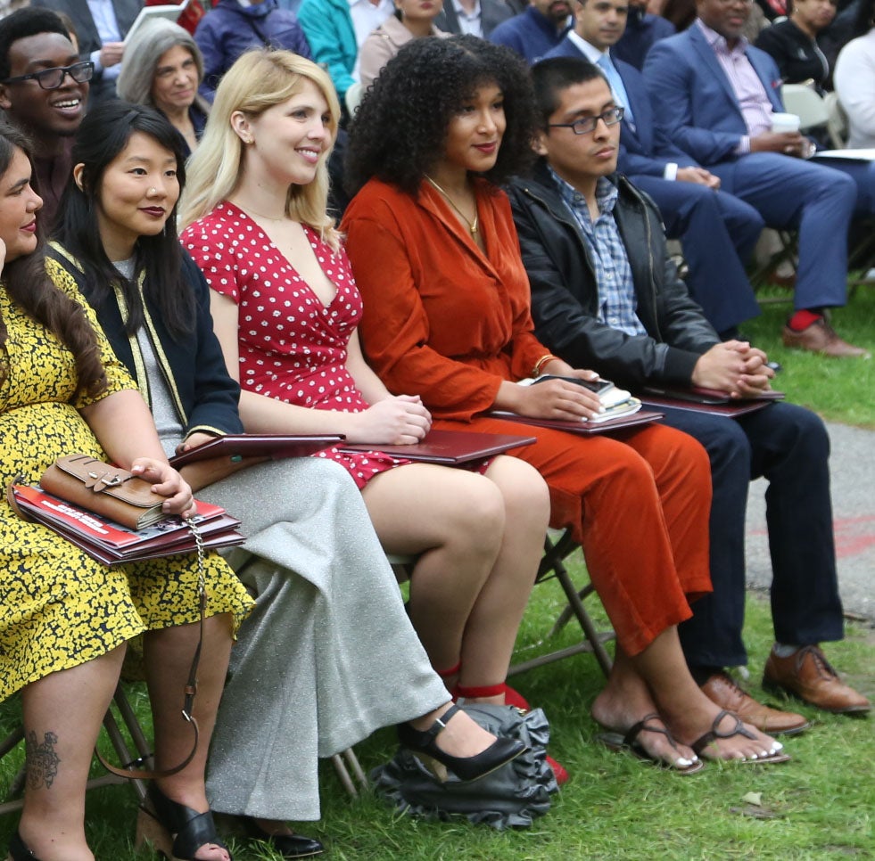 Four student honorees sit among Class Day attendees