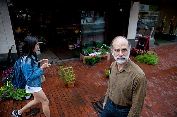 Woman with phone walking past Bruce Schneier