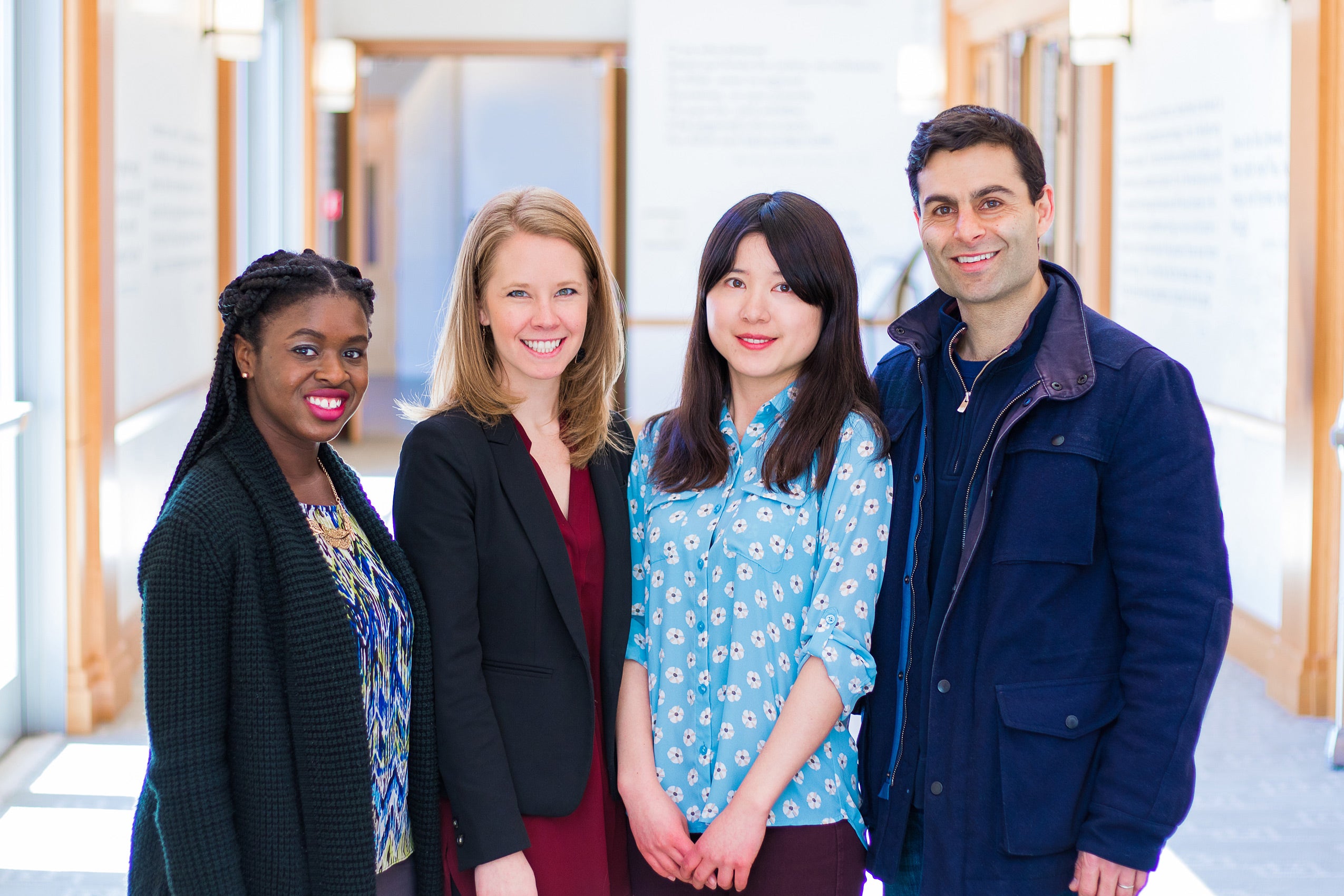Crystal Nwaneri, Marin Tollefson, Patrick Sharma, and Qiongyue Hu pose together in a bright room