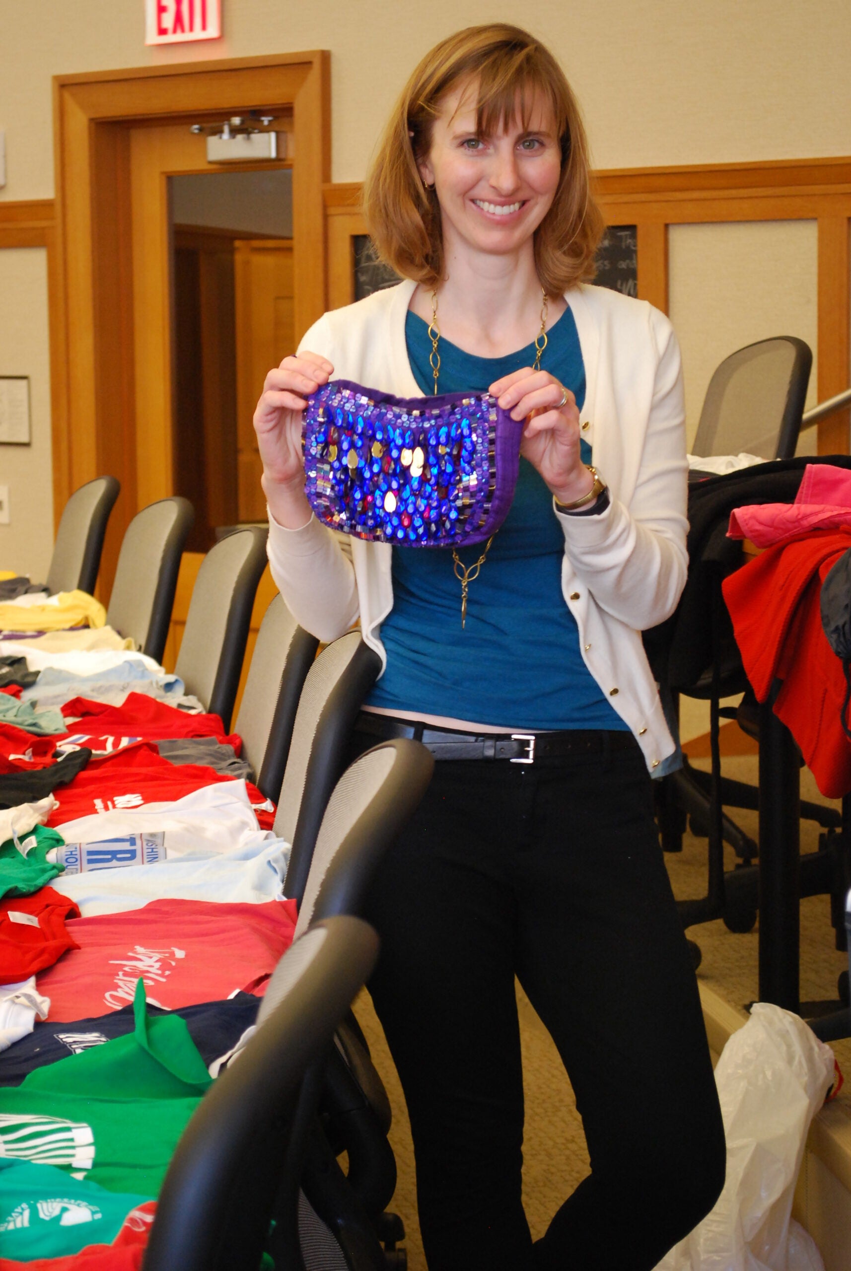 Anne Sargent holding up a sparkly purple purse