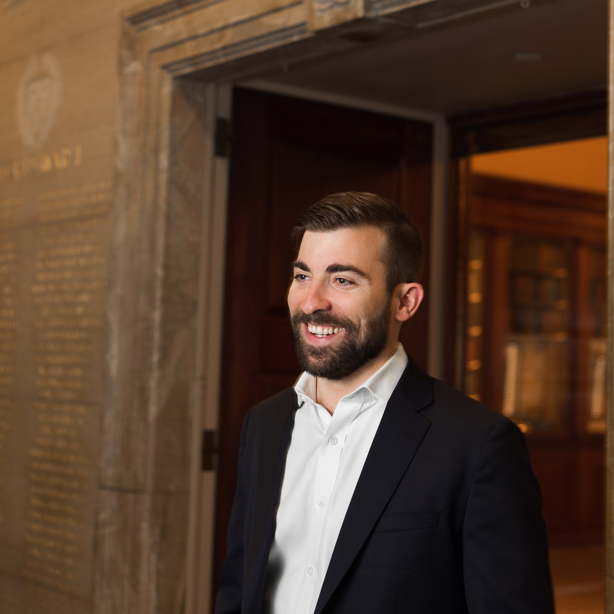 Logan Leslie at the doorway of the Caspersen Room at Harvard Law Library