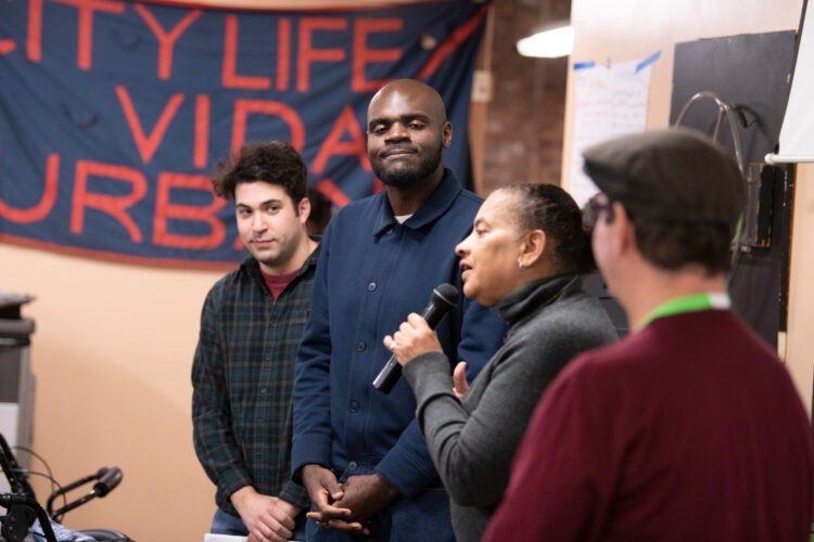 Image of four people presenting at the City Life Vida Urbana