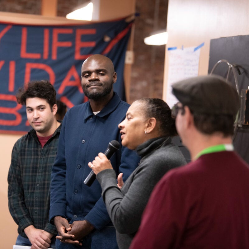 Image of four people presenting at the City Life Vida Urbana
