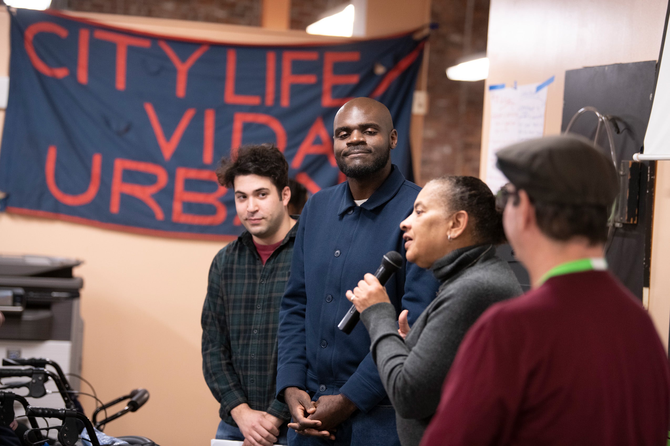 Image of four people presenting at the City Life Vida Urbana