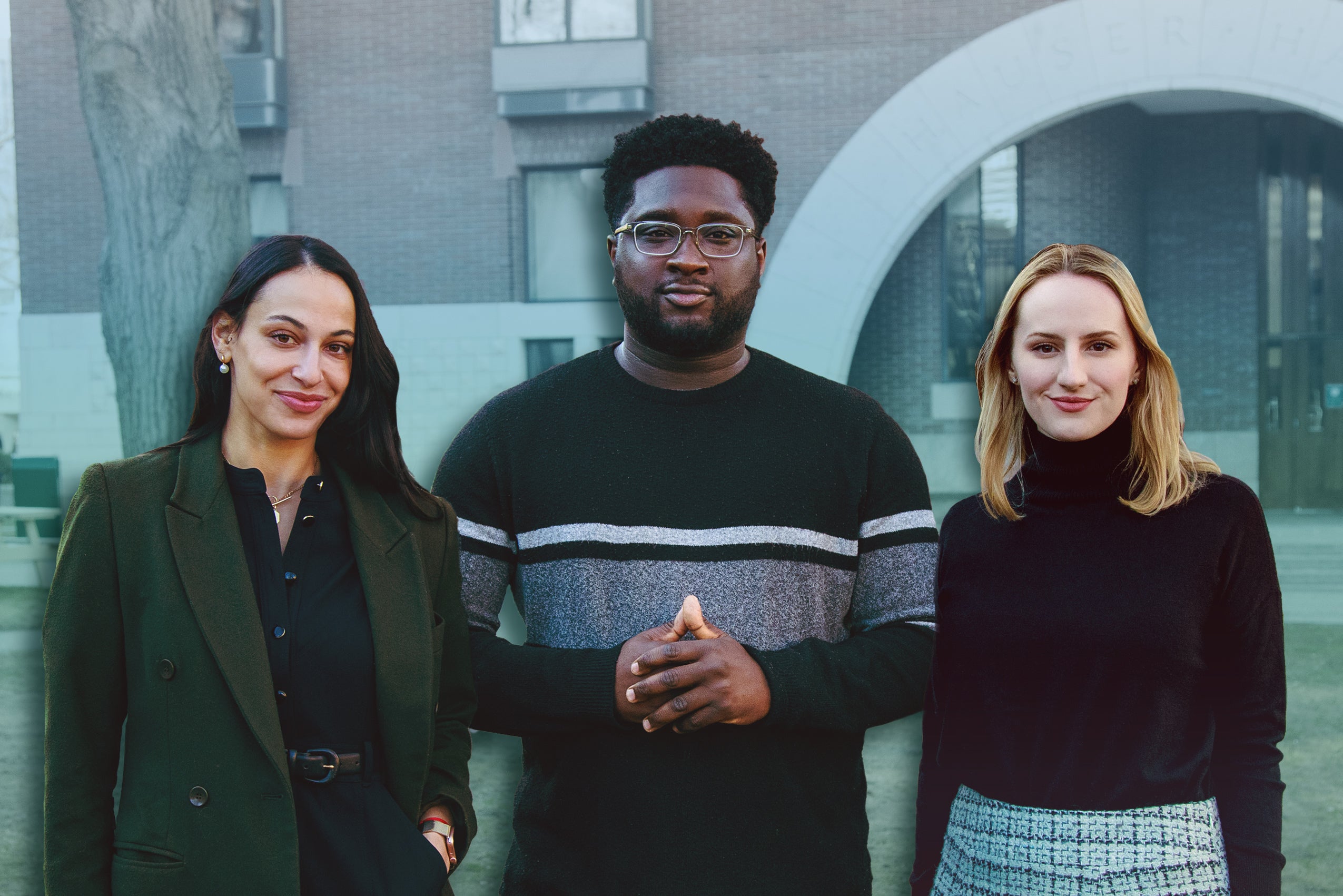 A woman in a green coat, a man in a black sweater, and a women in a black shirt stand in front of a building on the Harvard Law School campus.