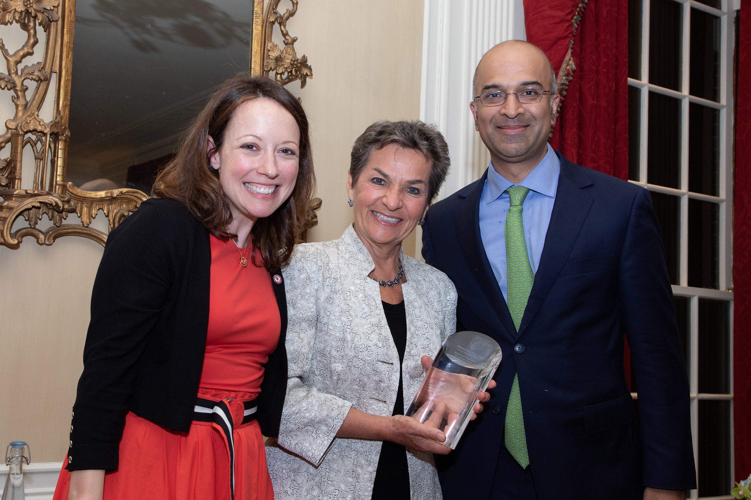 Christiana Figueres poses for a photo with two others while holding her Great Negotiator award.