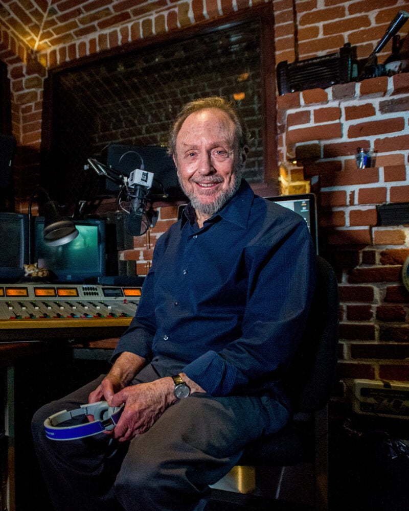 Portrait of a man sitting on a chair in a radio studio