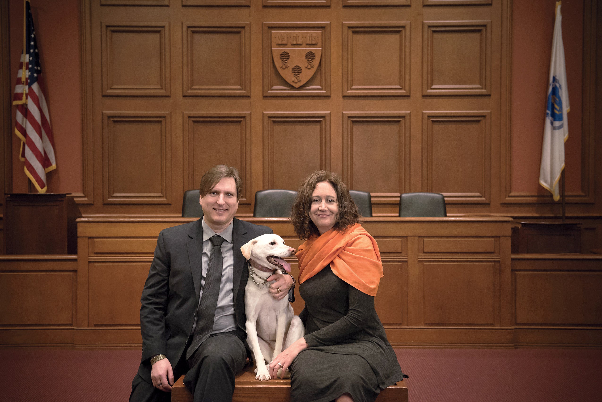 Chris Green and Kristen Stilt in courtroom with a white retriever dog
