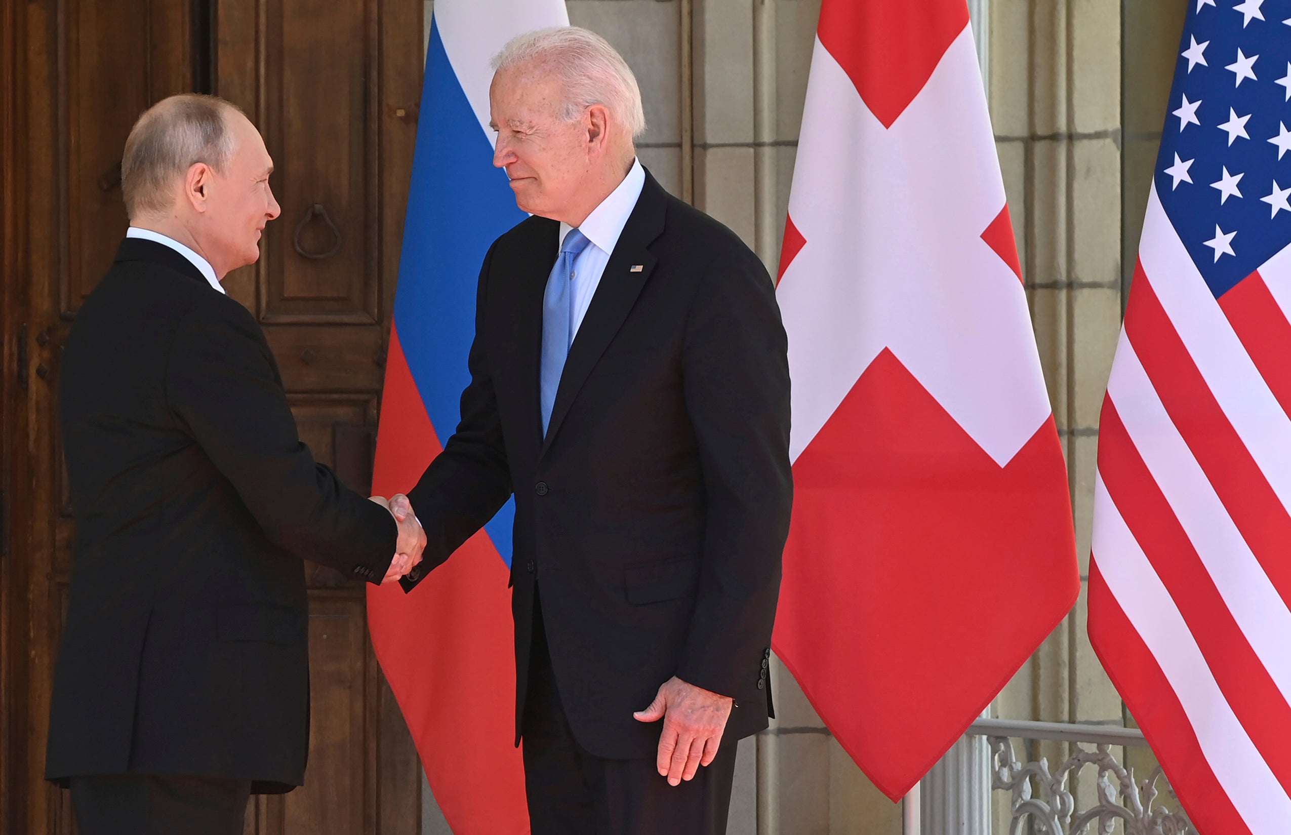 President Joe Biden and Russian President Vladimir Putin shaking hands