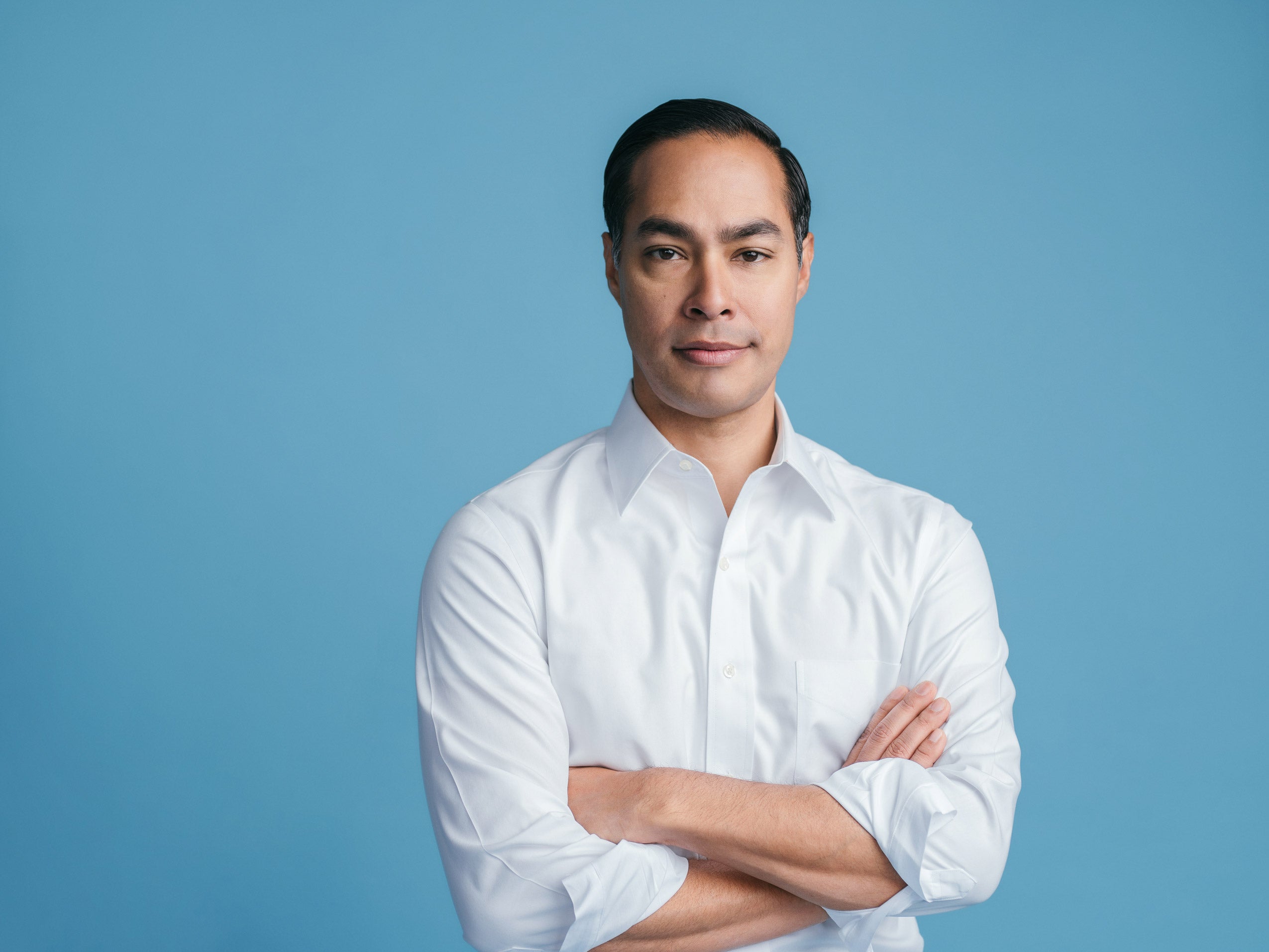 Portrait of Julian Castro wearing a white shirt with arms crossed