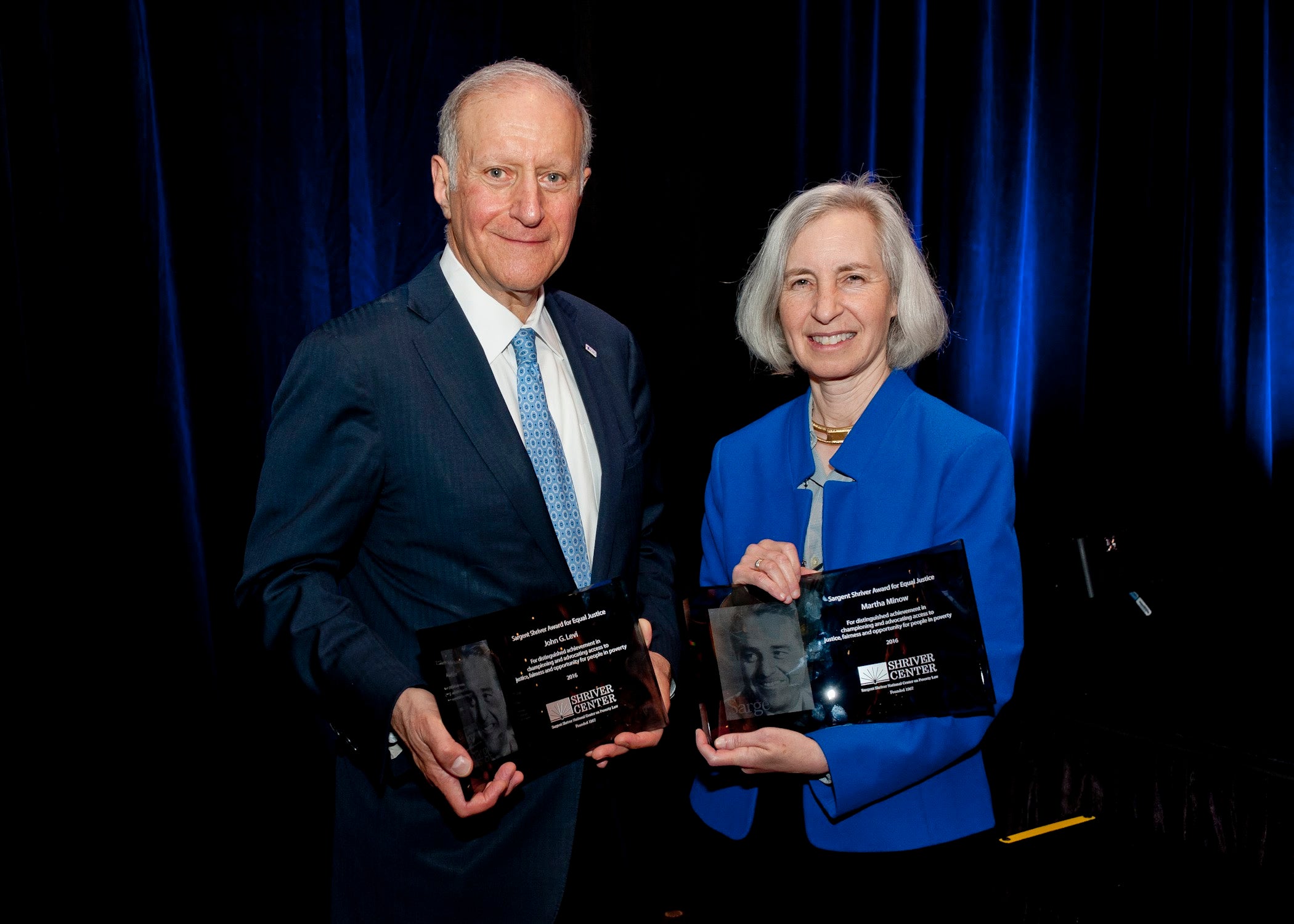 John Levi and Martha Minow posing together holding awards