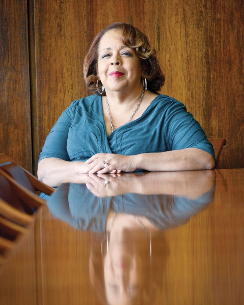 Photograph of Judge Fern Fisher at a table with her arms folded in front of her