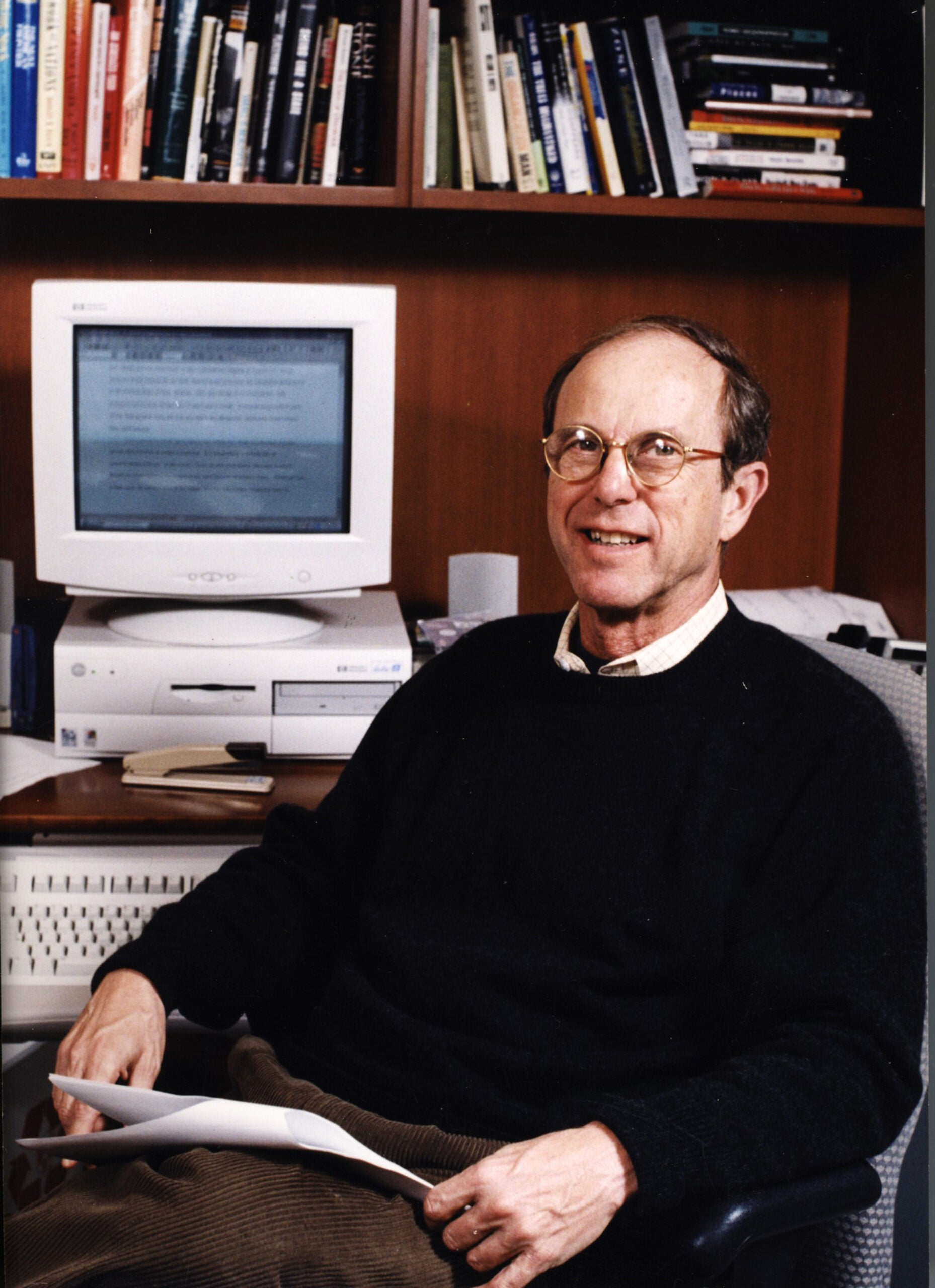 A man sitting in front of a computer in his office