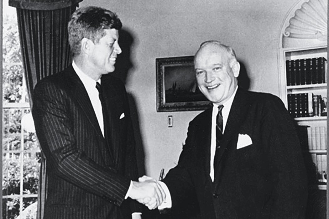 Black and white photo of President Kennedy shaking hands with James B. Donovan