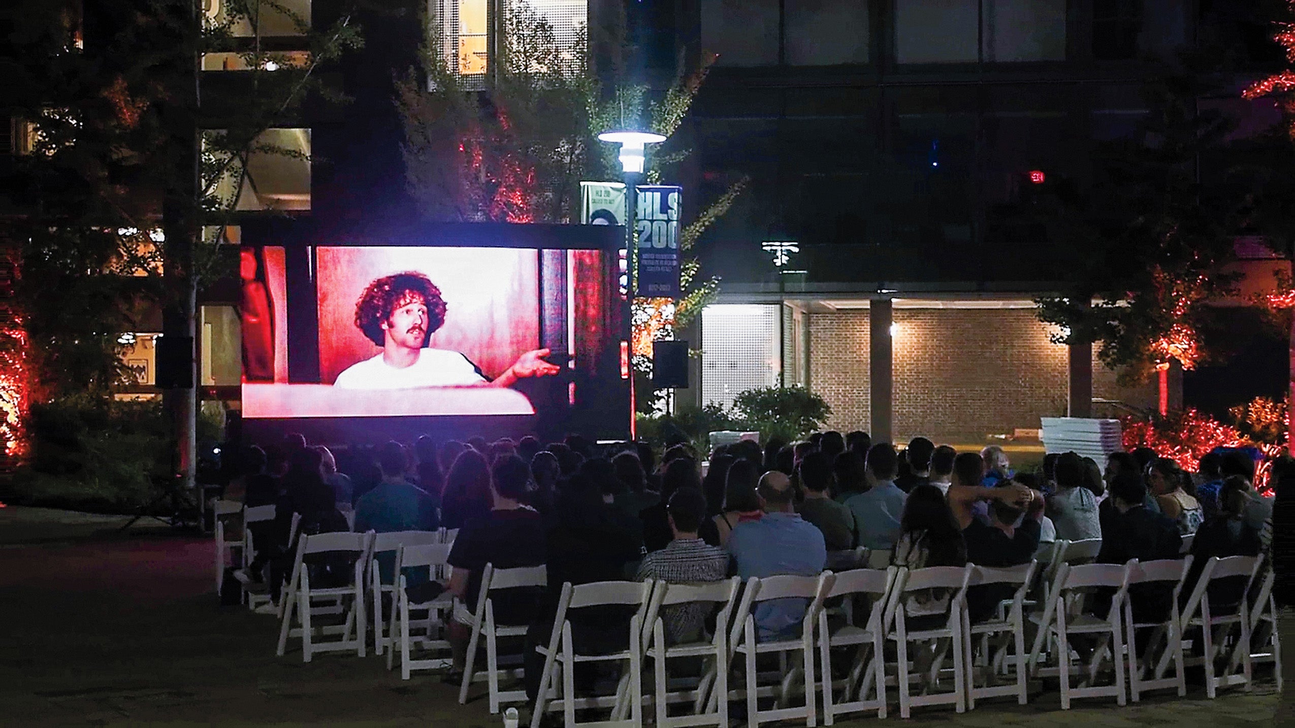 Audience watching ‘The Paper Chase’ outdoors