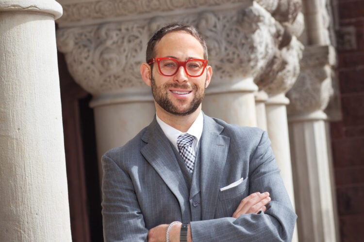 Glenn Cohen wearing bright red glasses