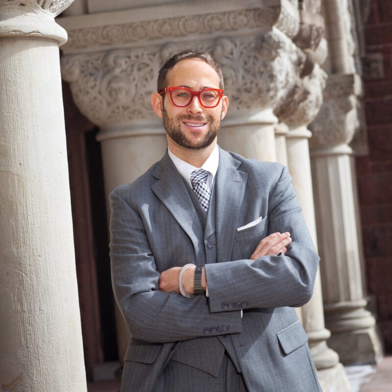 Glenn Cohen wearing bright red glasses