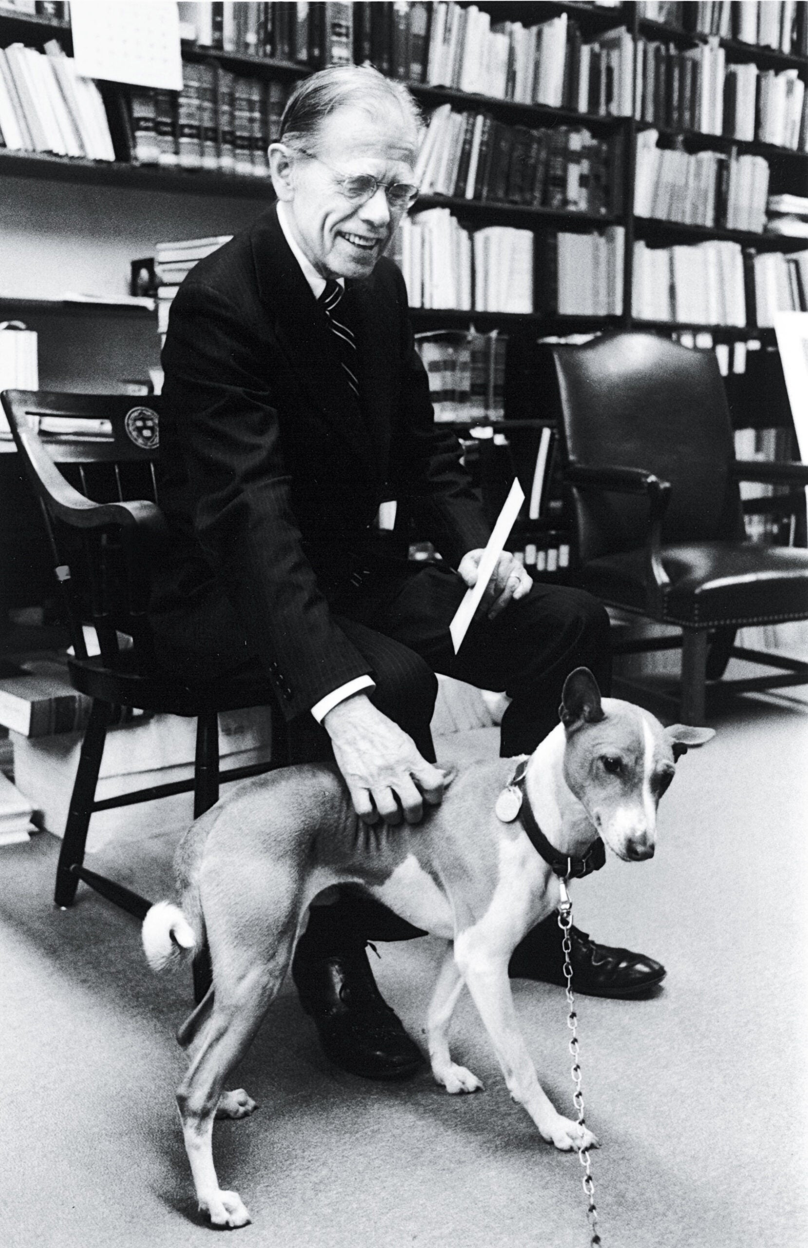 Clark Byse in 1983 in his office with his dog