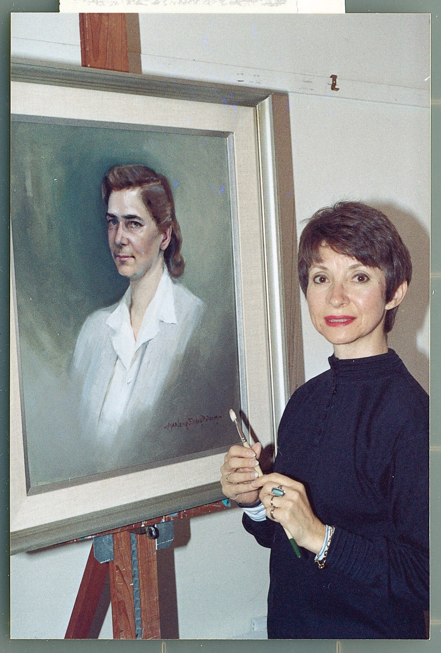 Marlene Evans Putnam with her portrait of Soia Mentschikoff