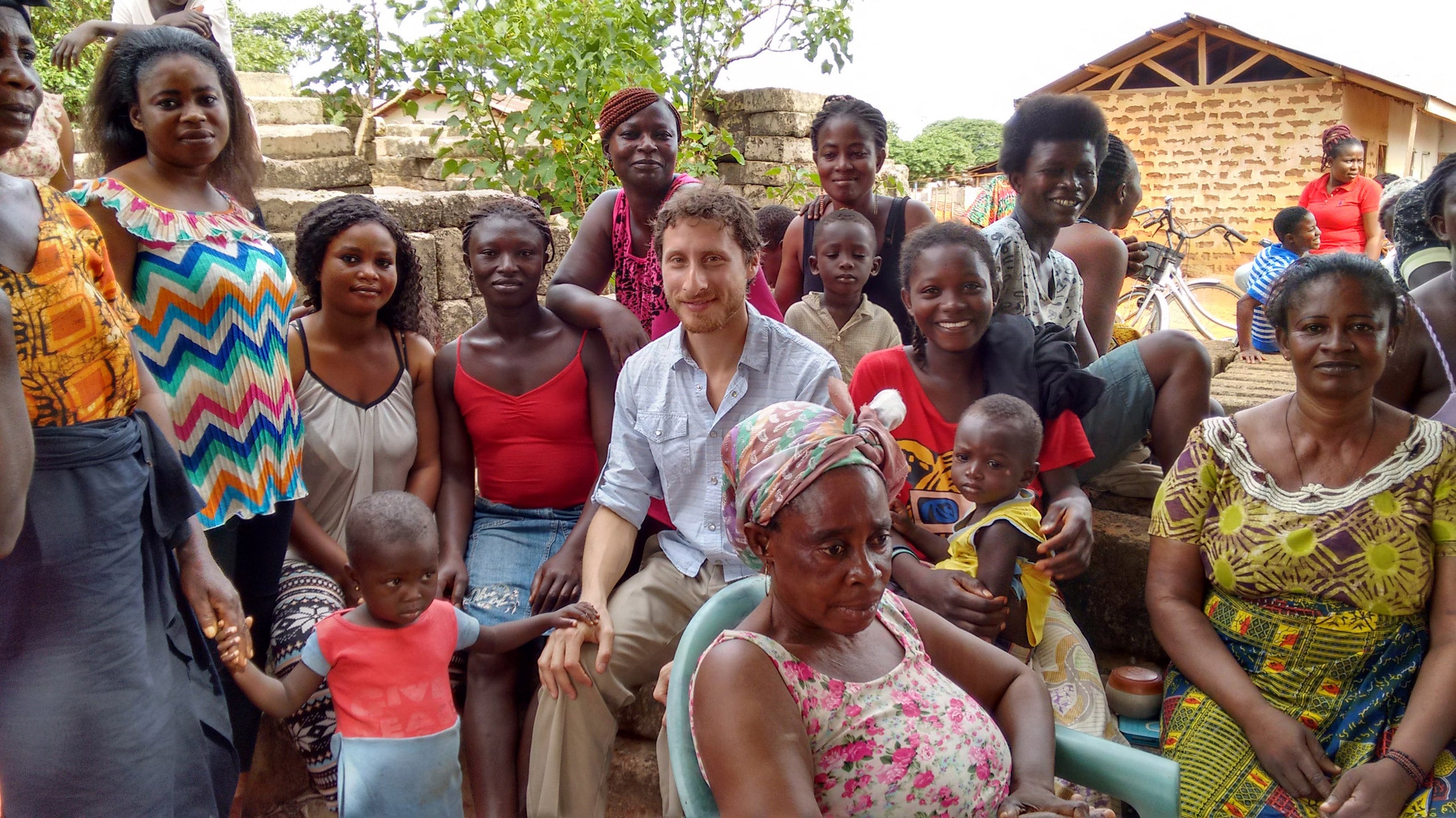 Jonathan Kaufman with a group of Ghananians dressed colorfully