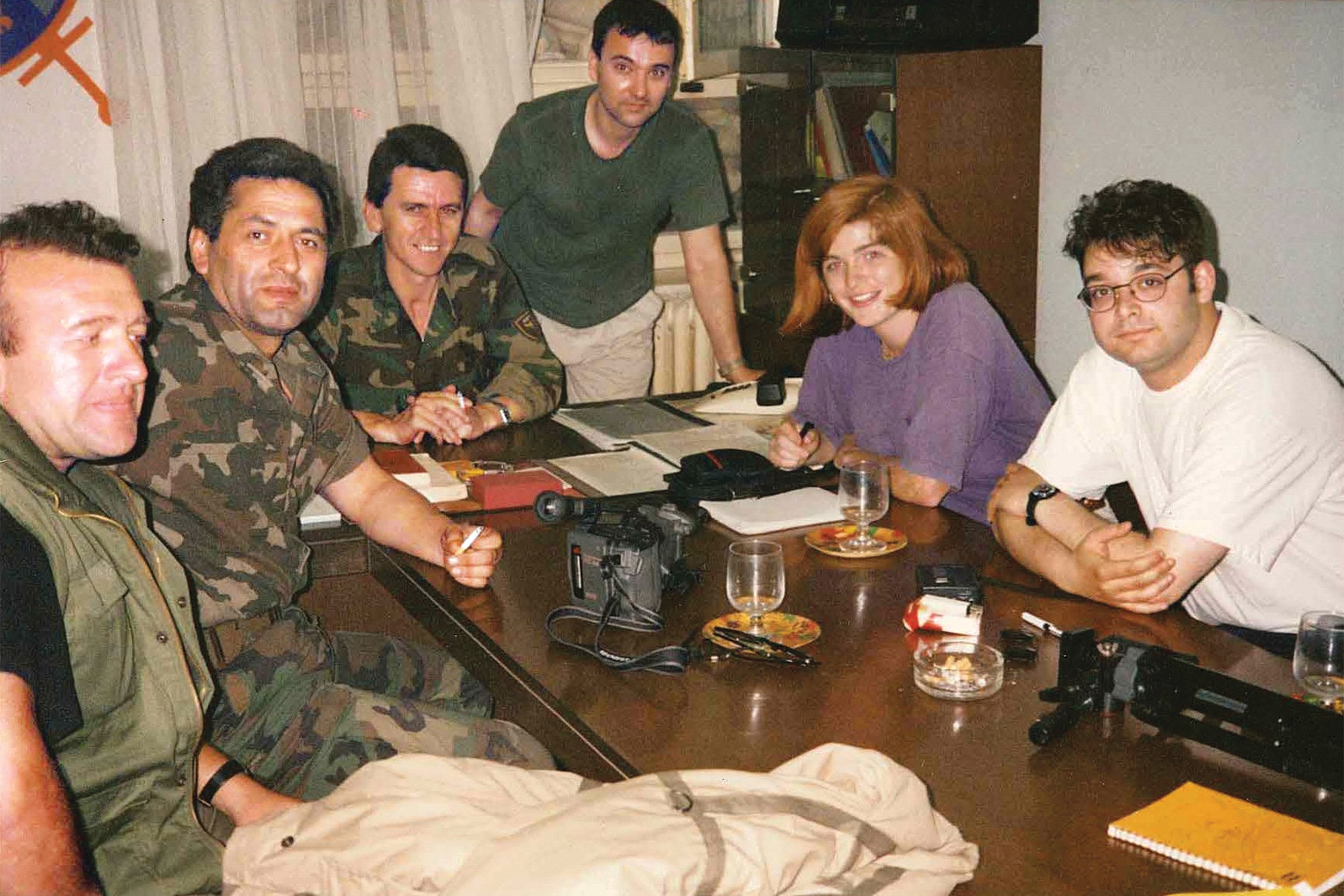 Samantha Power with a journalist and a friend interviewing a group of Bosnian military officers.