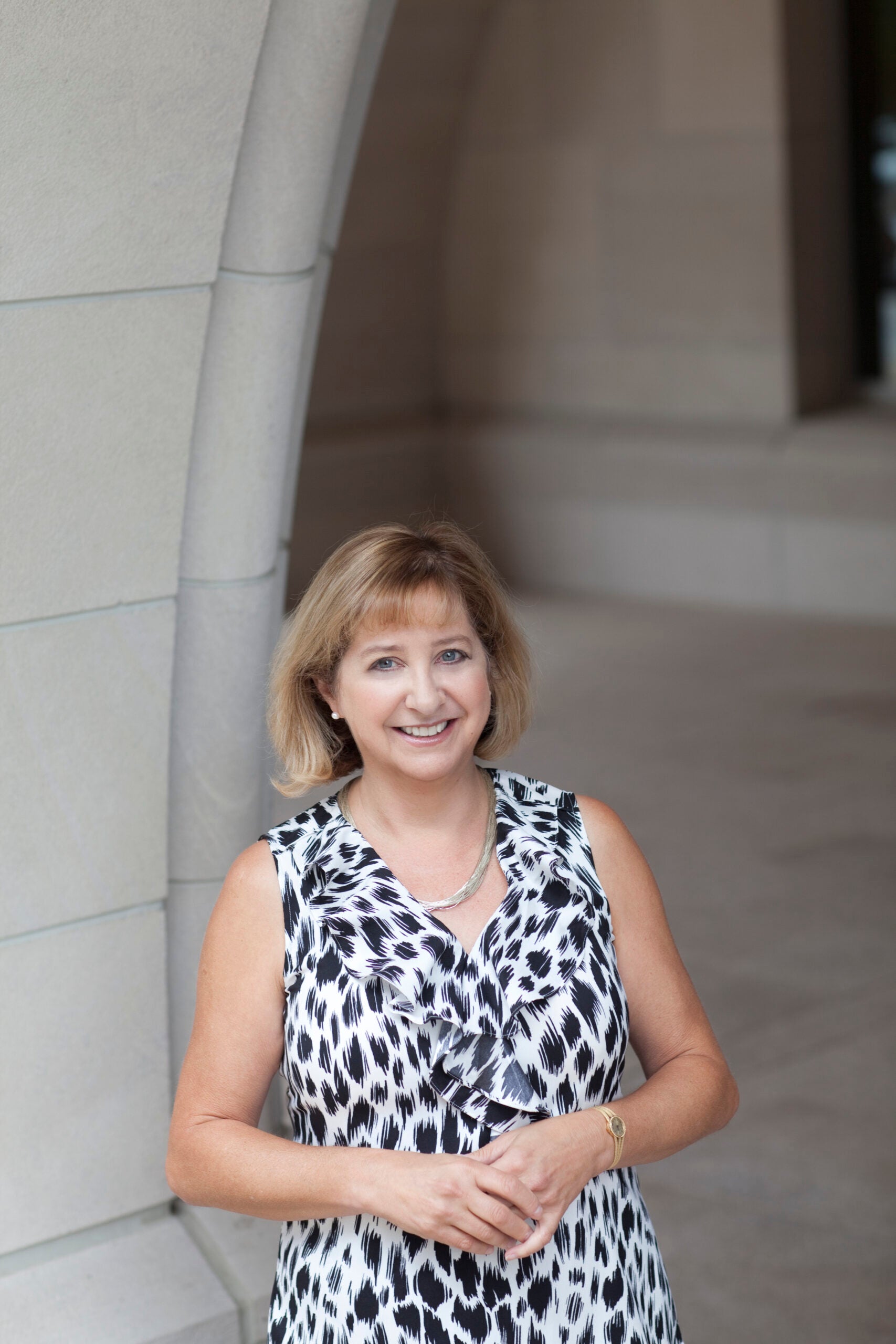 Wendy Jacobs in front of a stone column