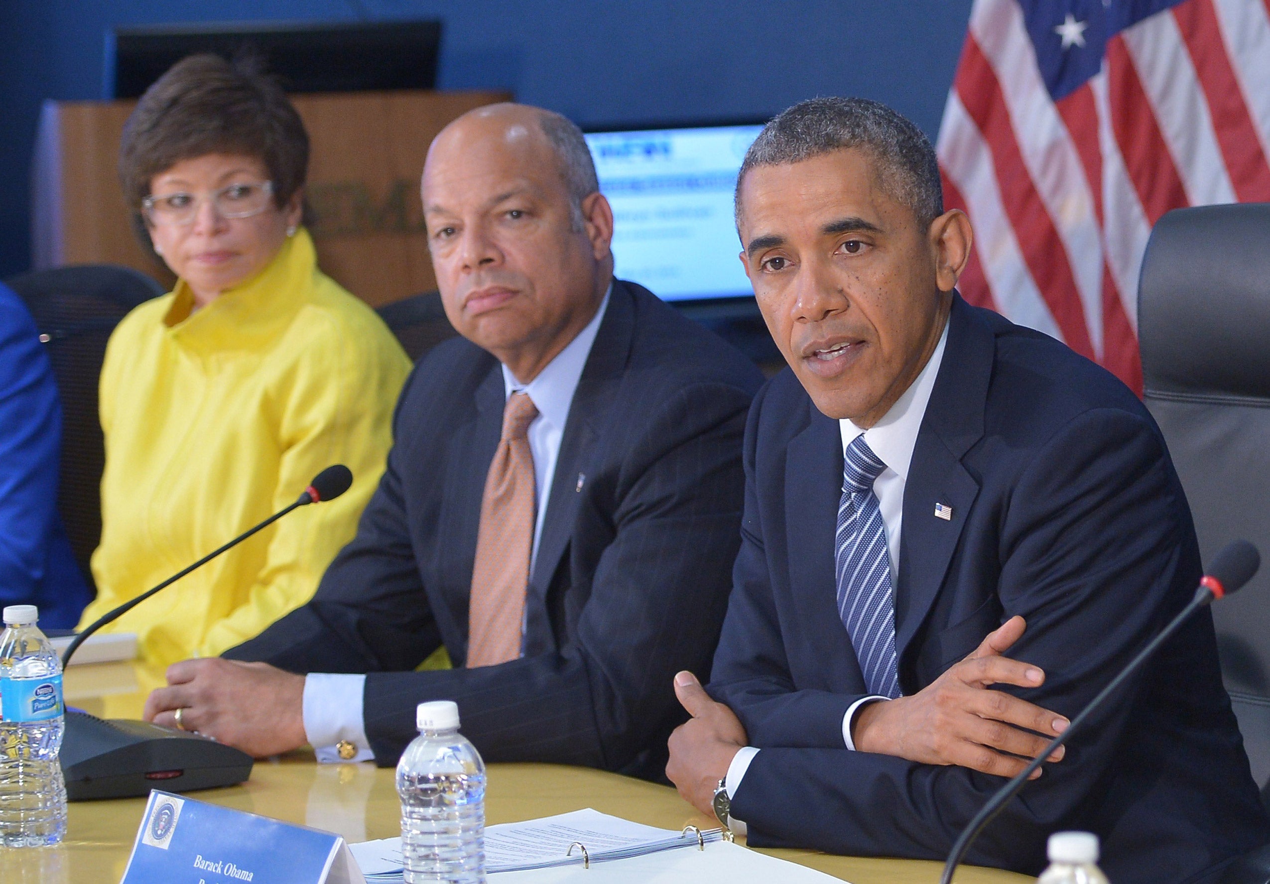 One woman and two men speaking at a meeting (one of the men is President Obama)