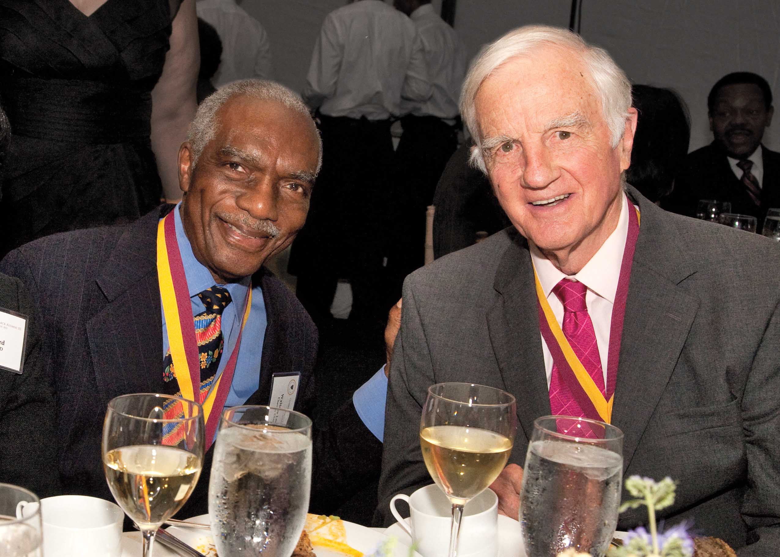 Walter J. Leonard and Derek C. Bok sitting together at a dinner table