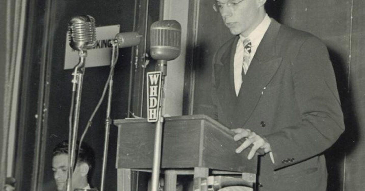 A young man at a podium with micr