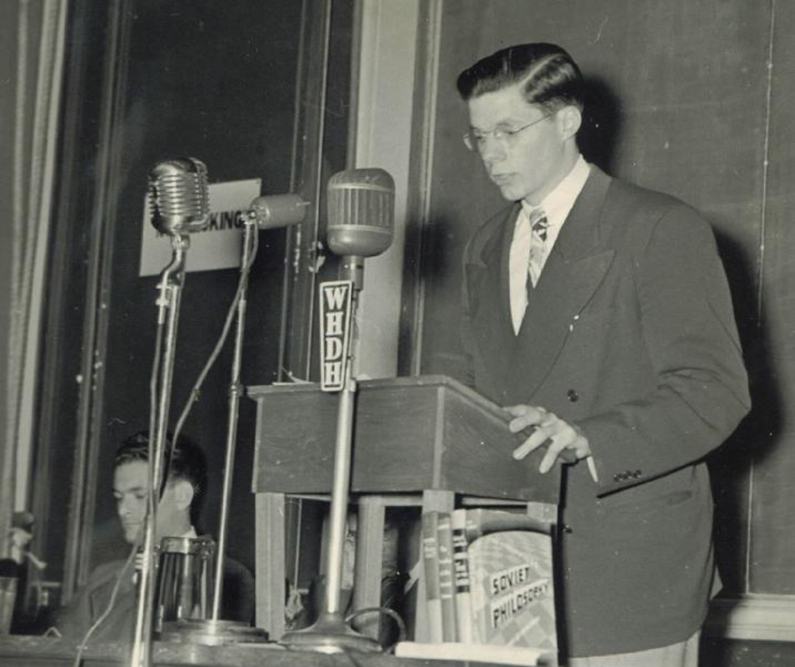 A young man at a podium with micr