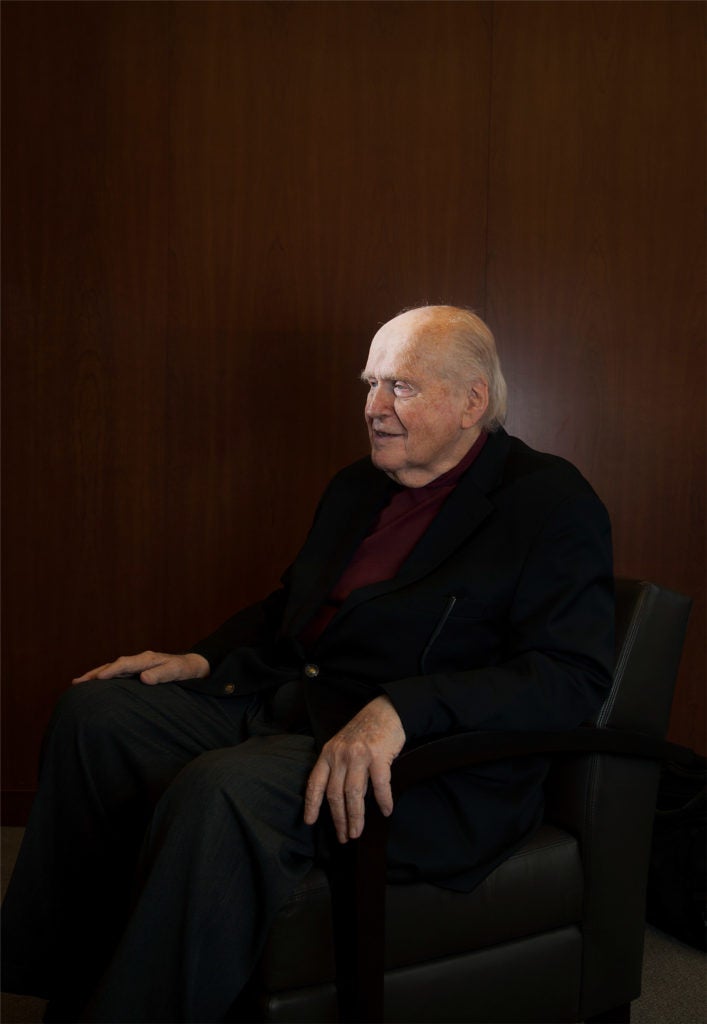 Portrait of a man sitting on a black chair