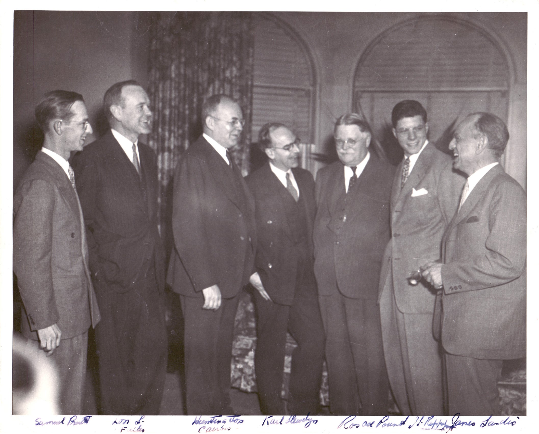 Group of people standing in suits