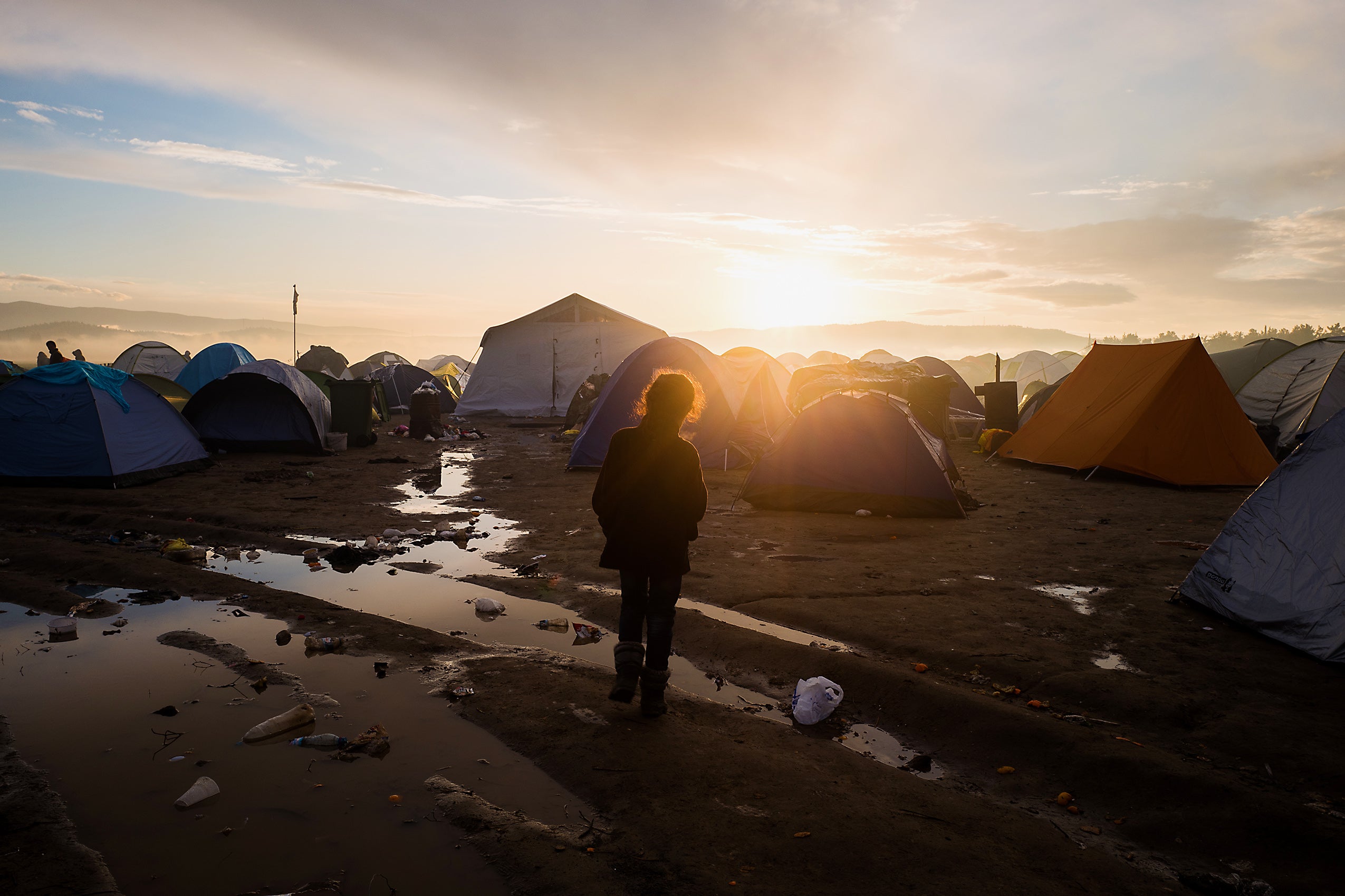 Refugee kid among tents