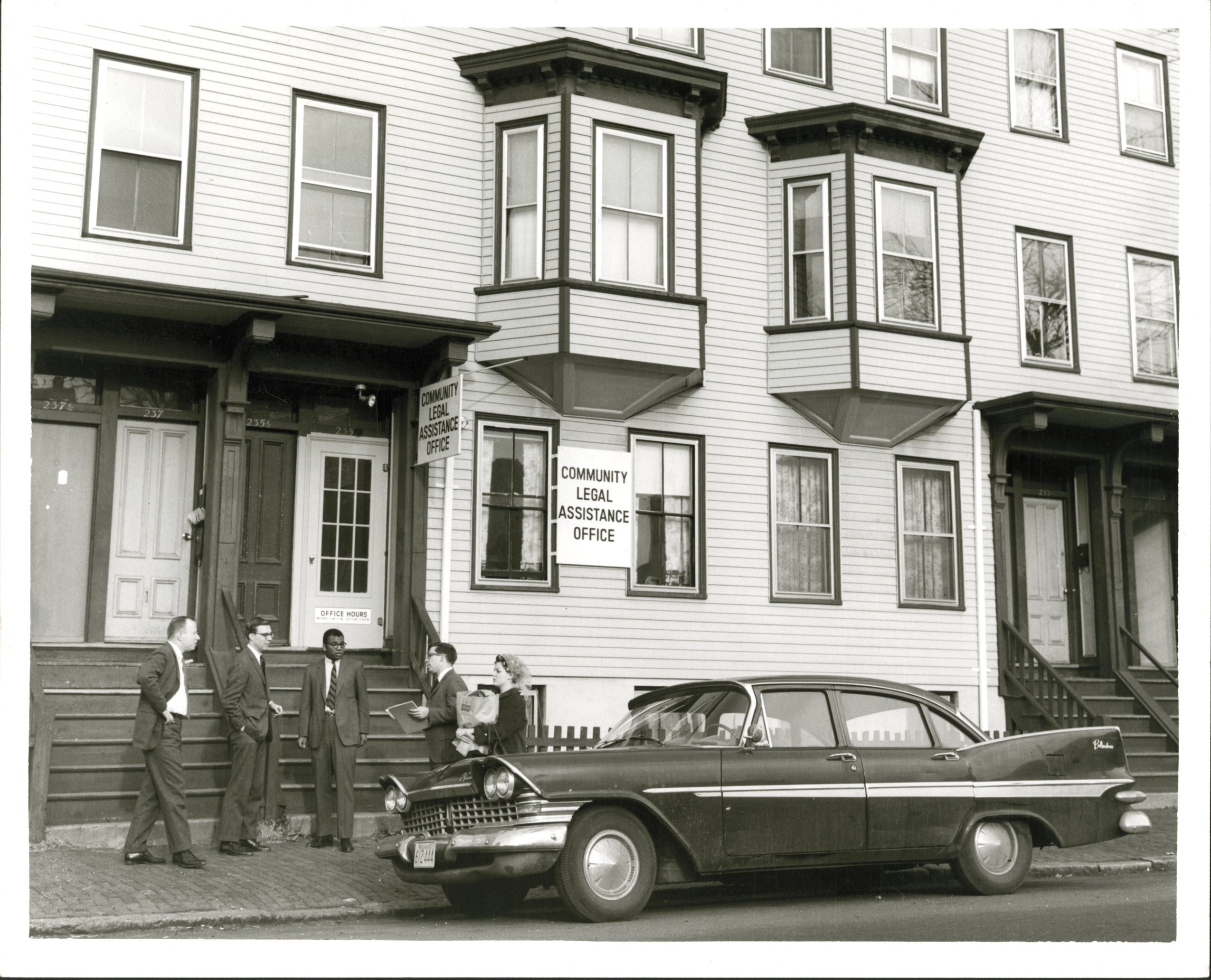 Four men and a woman outside the Community Legal Assistance Office, 1967