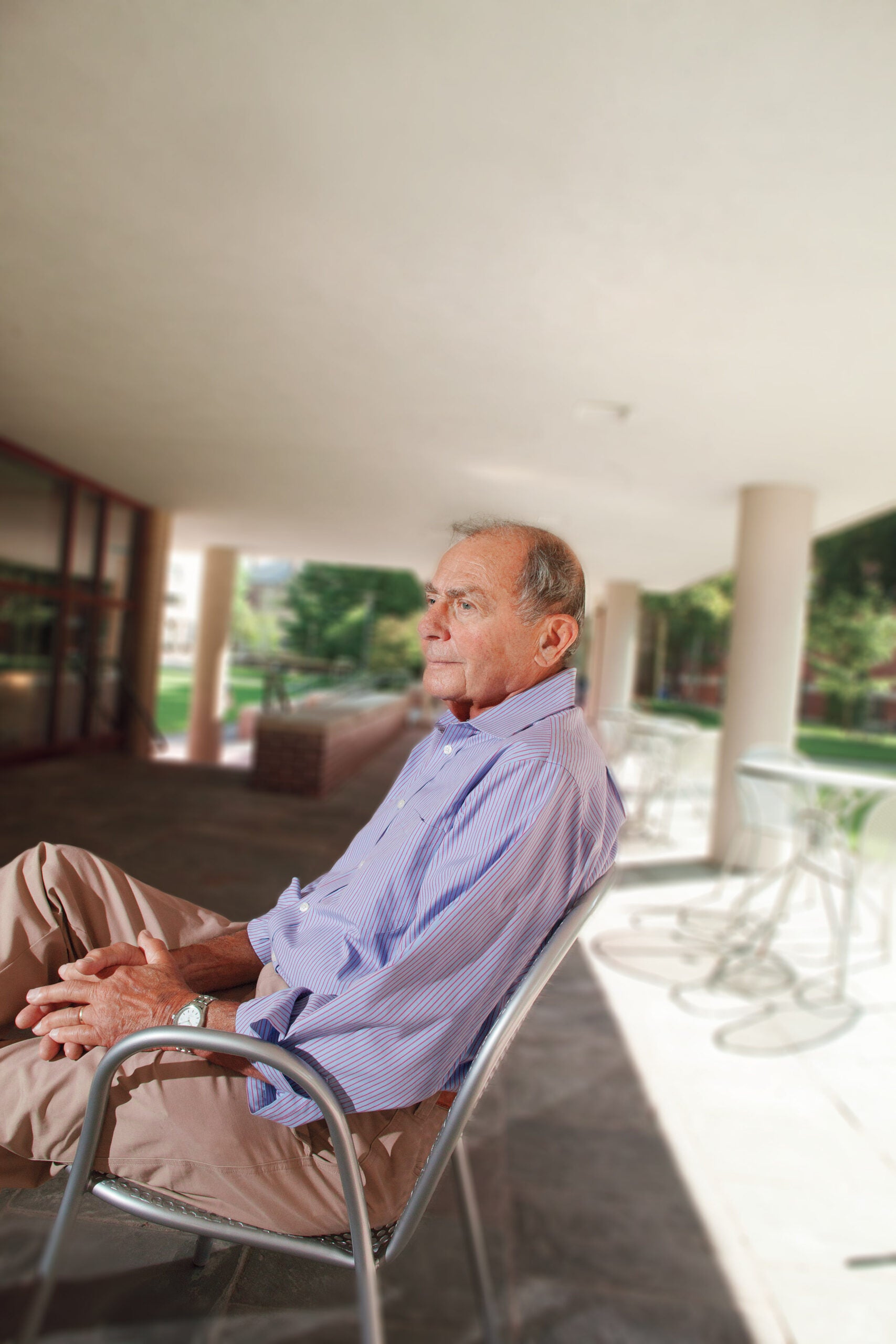 Sideview of man sitting outside in a chair