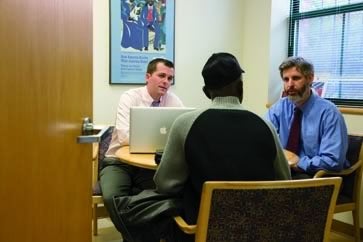 Andrew Roach ’13 and Dan Nagin, the supervising attorney, meet with a veteran