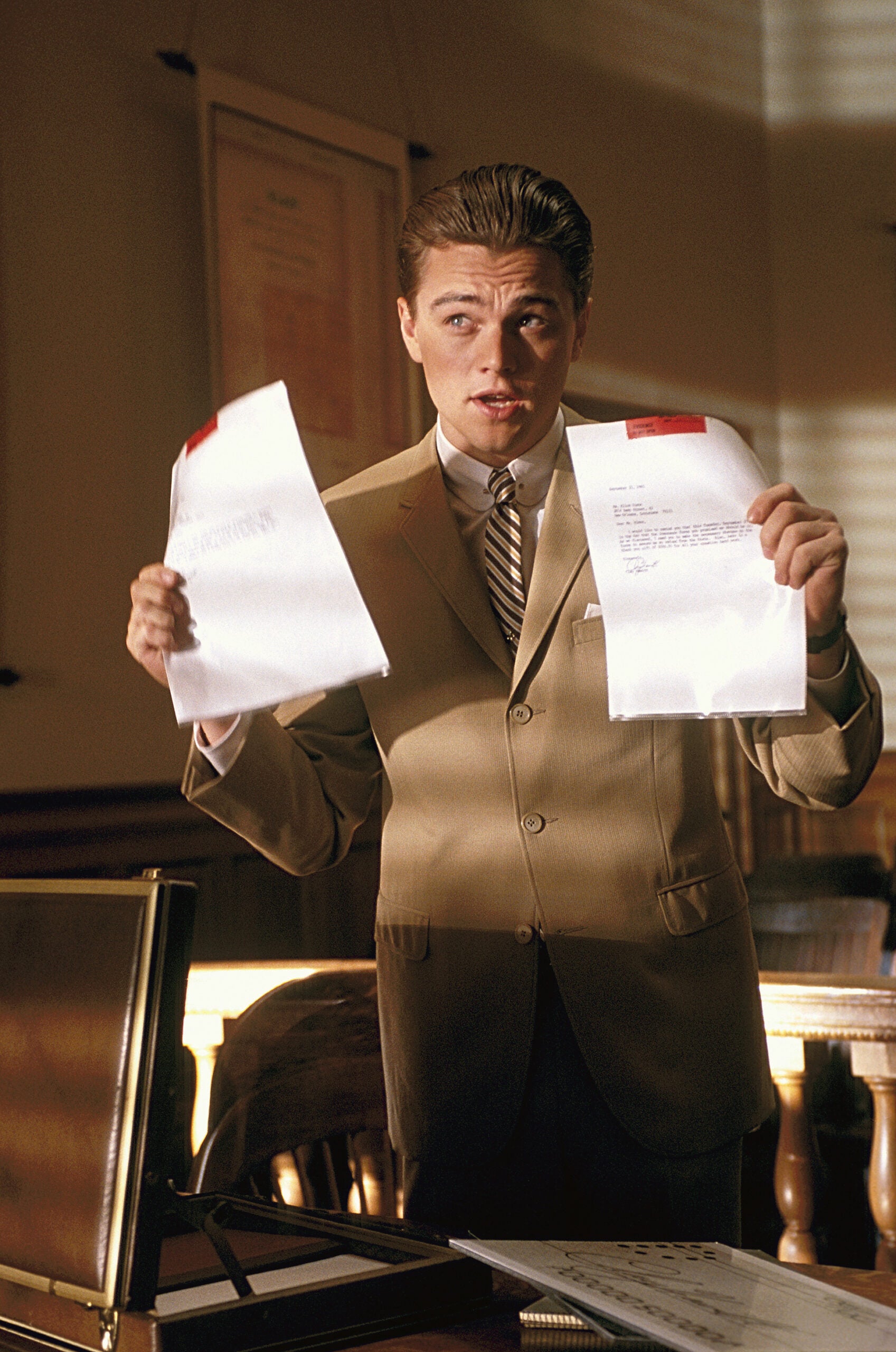 Leonardo DiCaprio holding up papers, pretending to be a lawyer
