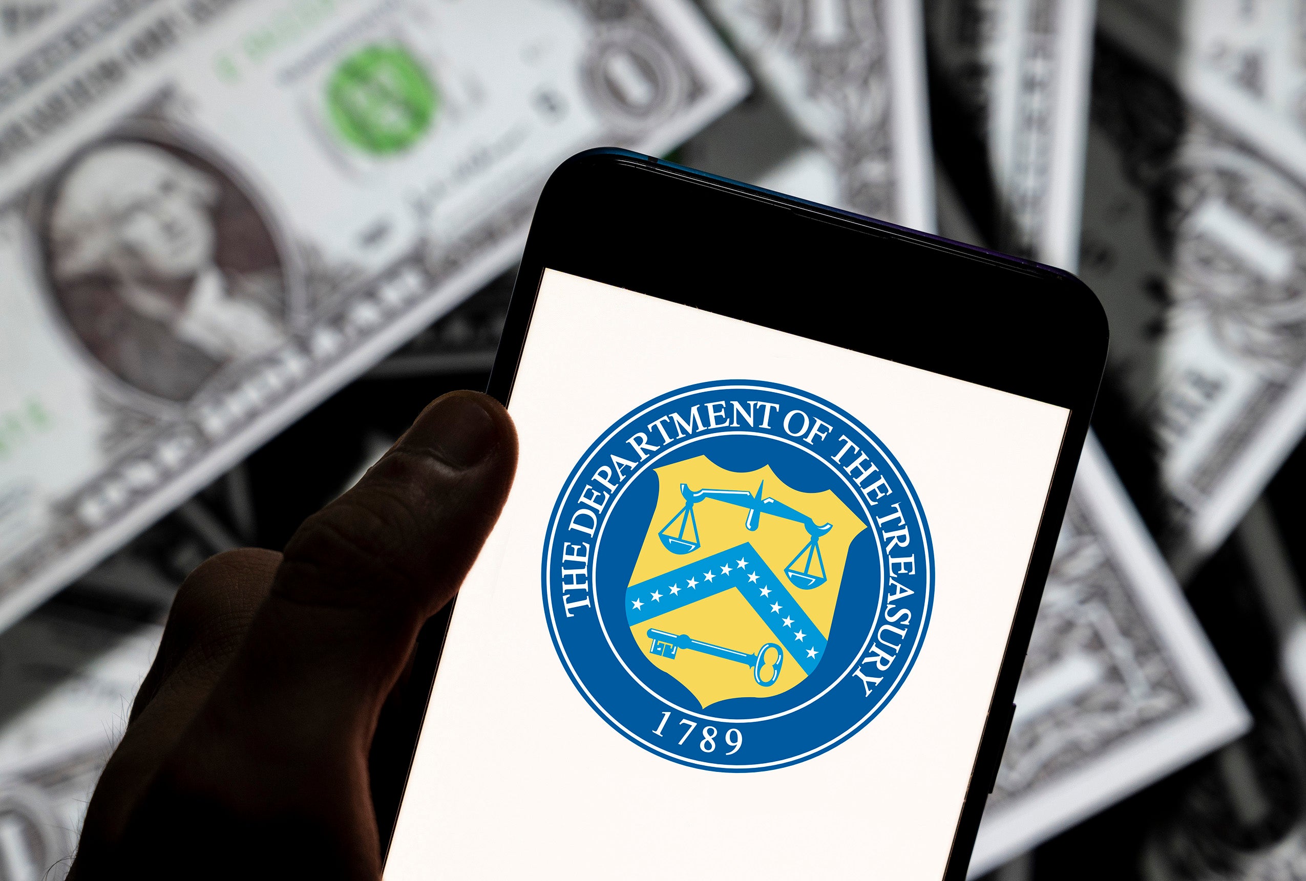 Photo illustration of U.S. Treasury Department seal on smartphone screen
